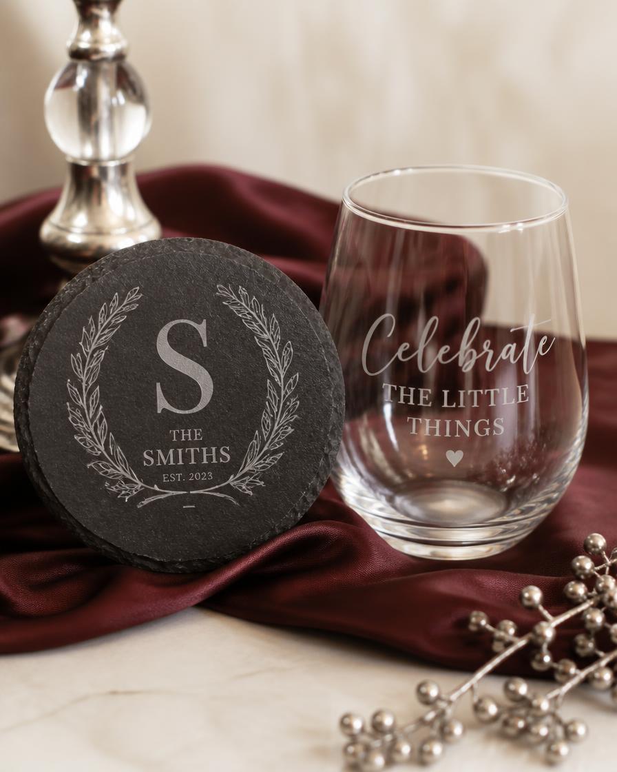 Laser-engraved slate coaster and engraved stemless wine glass on burgundy silk